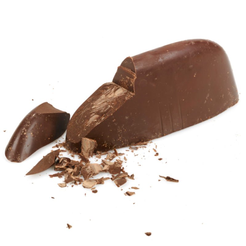 Unwrapped sliced and shaved Giandujotto large solid block of premium Italian dark chocolate. Dark chocolate shavings.