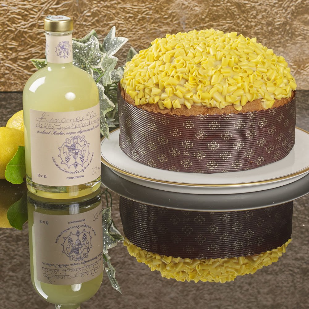 Limoncello hamper contents shown with cake on a plate next to bottle of limoncello 